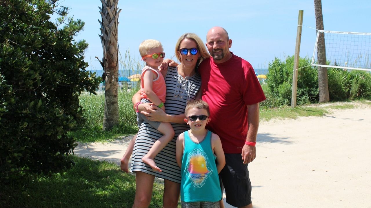 Family standing on volleyball court