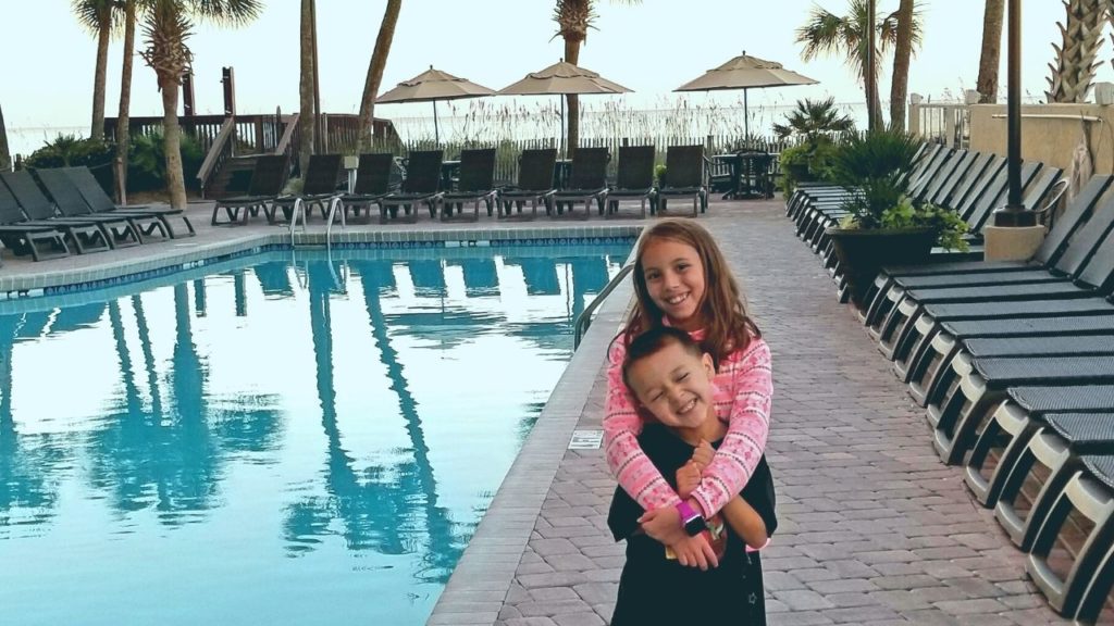 Two kids by oceanfront pool at Ocean Reef Resort