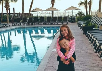Two kids by oceanfront pool at Ocean Reef Resort